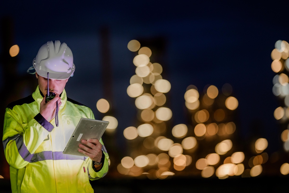 Contractor reviewing leads on tablet at night